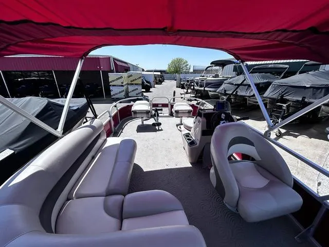 Slide: The Image of 2014 Sun Tracker Bass Buggy 18 DLX pontoon boat with red canopy and spacious seating. - 10