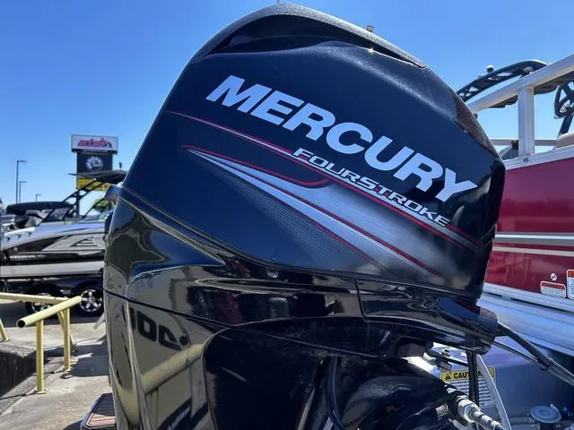 Slide: The Image of Mercury FourStroke engine on 2014 Sun Tracker Bass Buggy 18 DLX boat, outdoor display. - 3