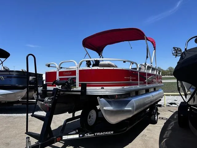 Slide: The Image of 2014 Sun Tracker Bass Buggy 18 DLX pontoon boat with red canopy on trailer. - 6