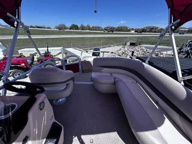 Slide: The Image of 2014 Sun Tracker Bass Buggy 18 DLX pontoon boat interior with seating and steering wheel. - 8