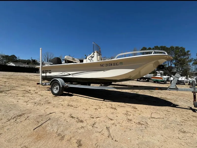 The Image of 2017 Carolina Skiff 18 JVX CC boat on trailer, parked on sandy ground. - 1