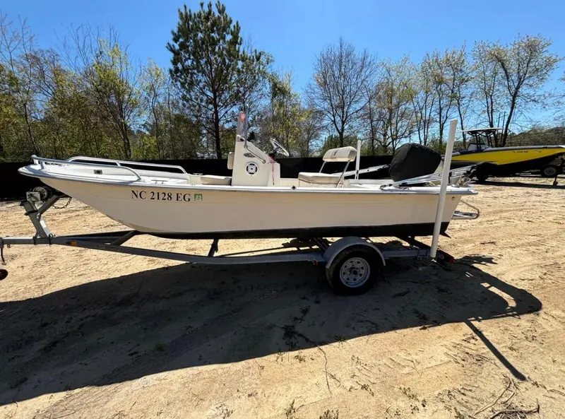 Slide: The Image of 2017 Carolina Skiff 18 JVX CC boat on trailer, parked outdoors. - 2