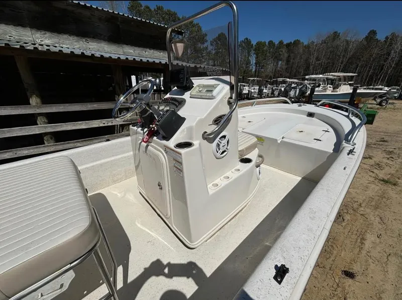 Slide: The Image of 2017 Carolina Skiff 18 JVX CC boat with center console, parked outdoors. - 8