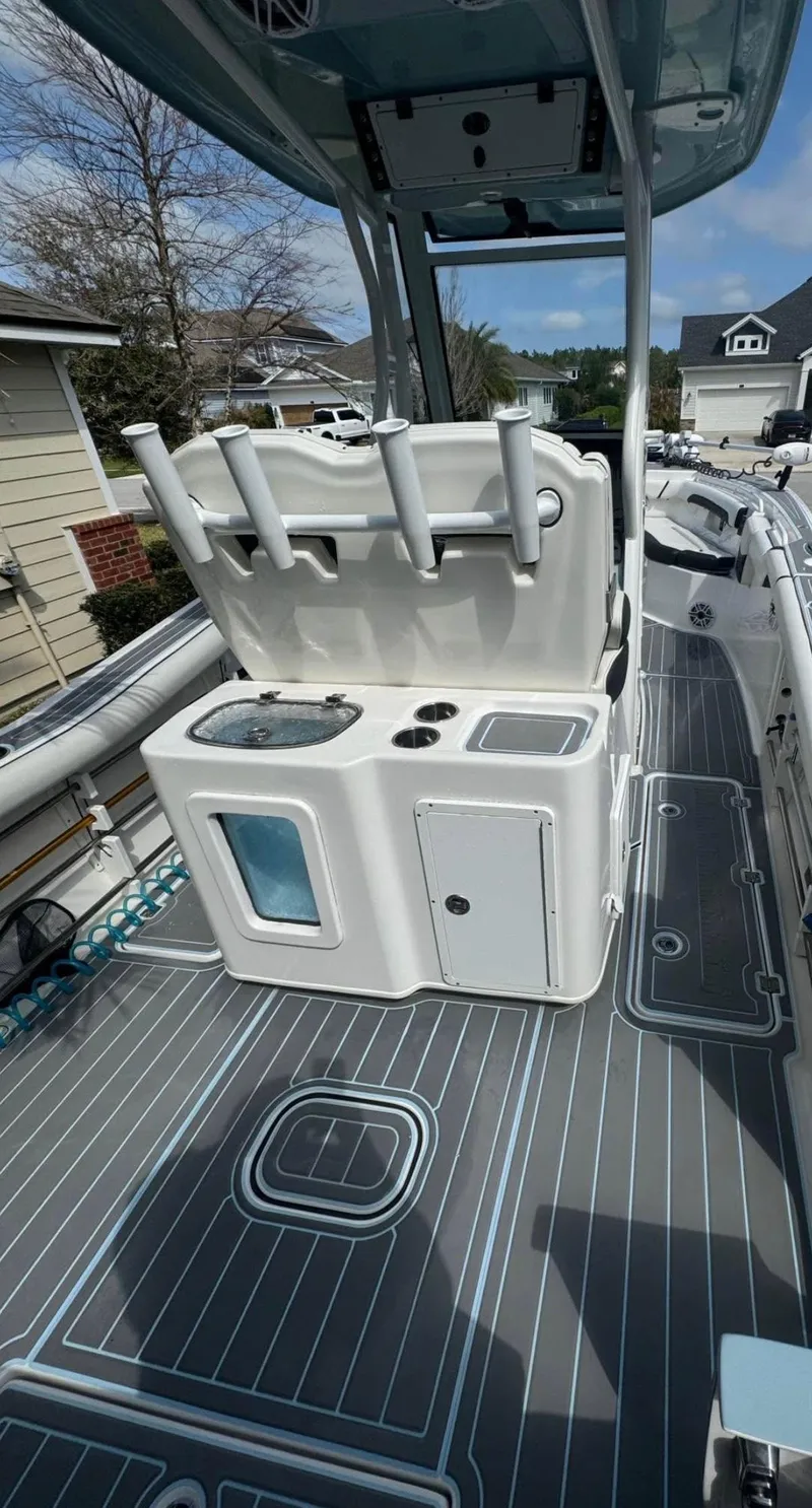 Slide: The Image of 2022 Tidewater 272 CC Adventure boat interior with fishing rod holders and storage compartments. - 9