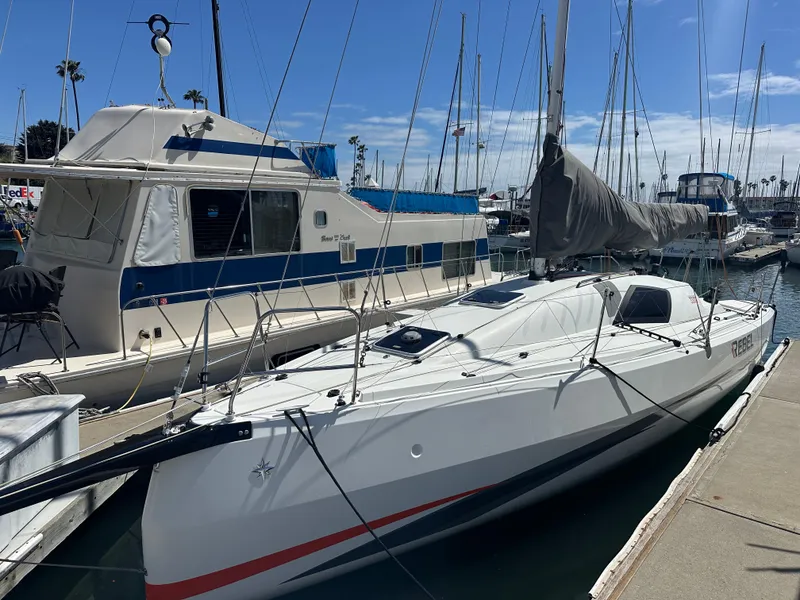Slide: The Image of 2021 Jeanneau Sun Fast 3300 sailboat docked at marina under clear blue sky. - 0