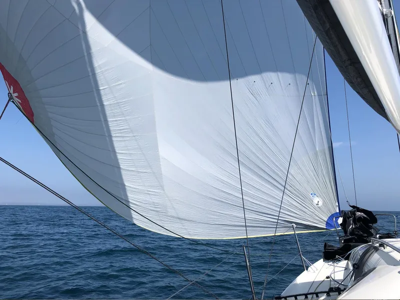 Slide: The Image of 2021 Jeanneau SUNFAST 3300 sailing with full sails on open water. - 15