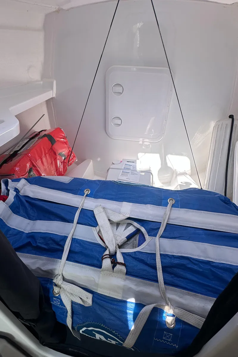 Slide: The Image of Interior of 2021 Jeanneau Sun Fast 3300 sailboat with striped bag and safety equipment. - 24