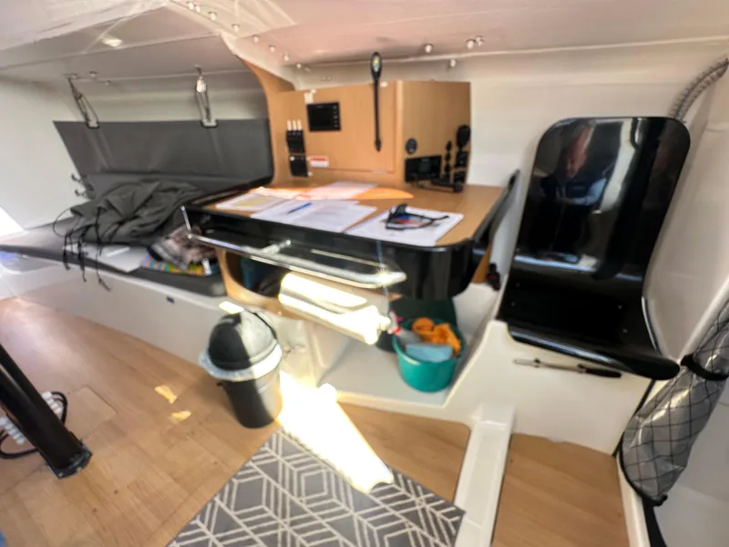 Slide: The Image of Interior of 2021 Jeanneau Sun Fast 3300 sailboat with navigation station and seating area. - 27