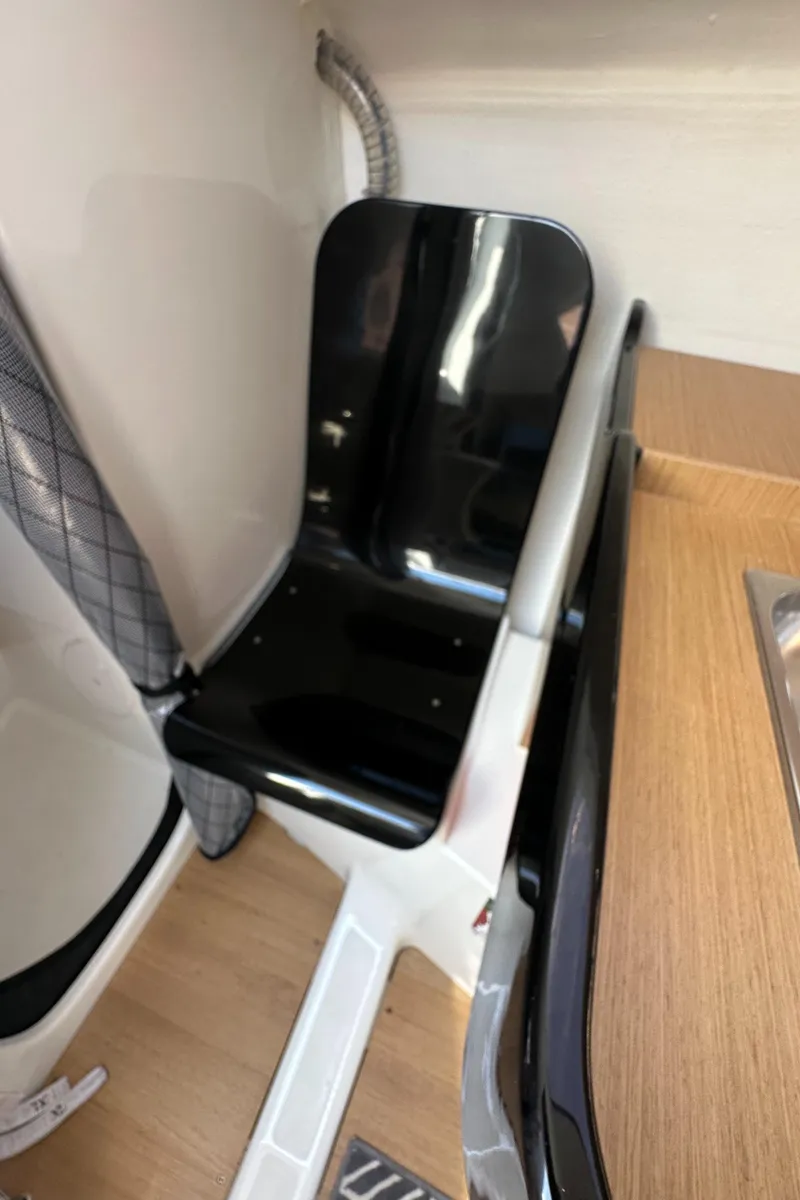 Slide: The Image of Interior of 2021 Jeanneau Sun Fast 3300 sailboat, featuring sleek black seating. - 28