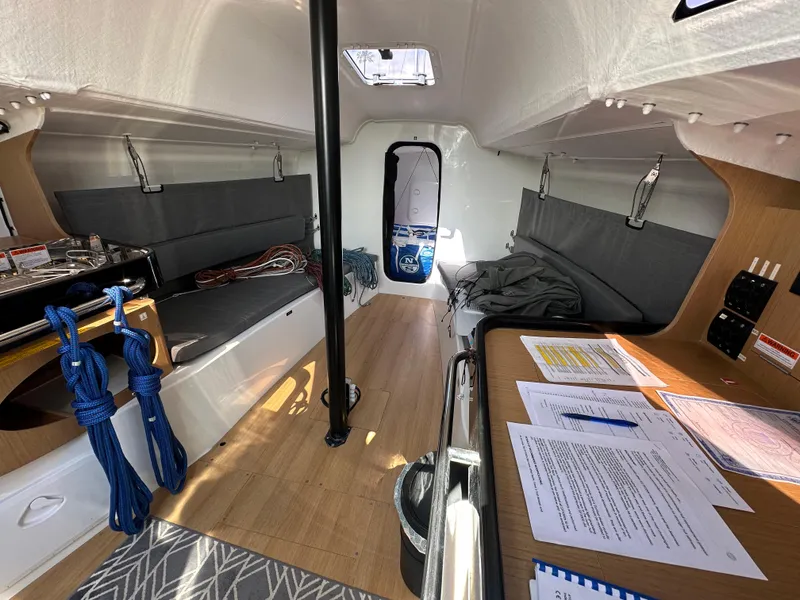 Slide: The Image of Interior of 2021 Jeanneau Sun Fast 3300 sailboat with seating, table, and nautical equipment. - 33