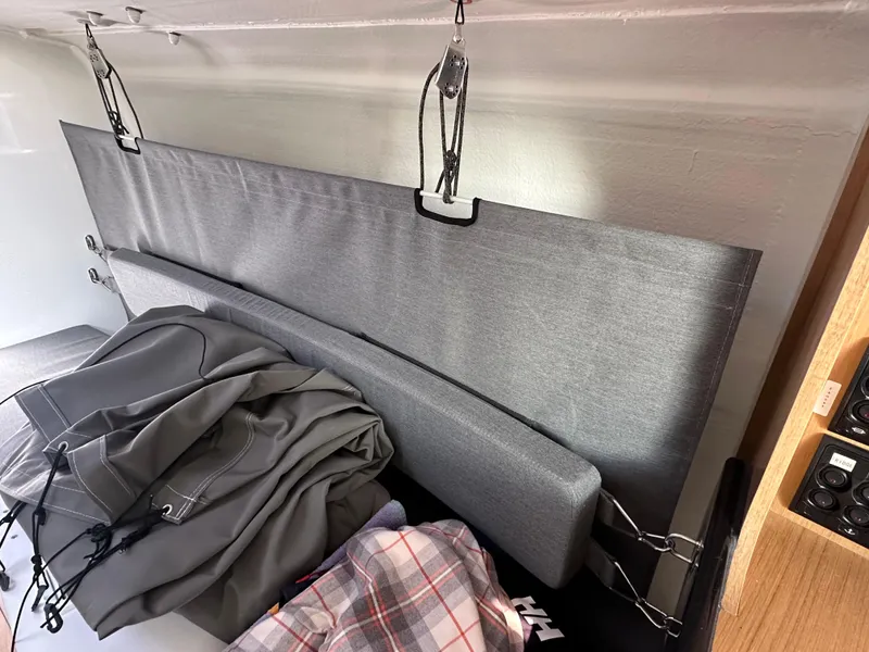 Slide: The Image of Interior of 2021 Jeanneau Sun Fast 3300 sailboat with cushions and folded sails. - 34