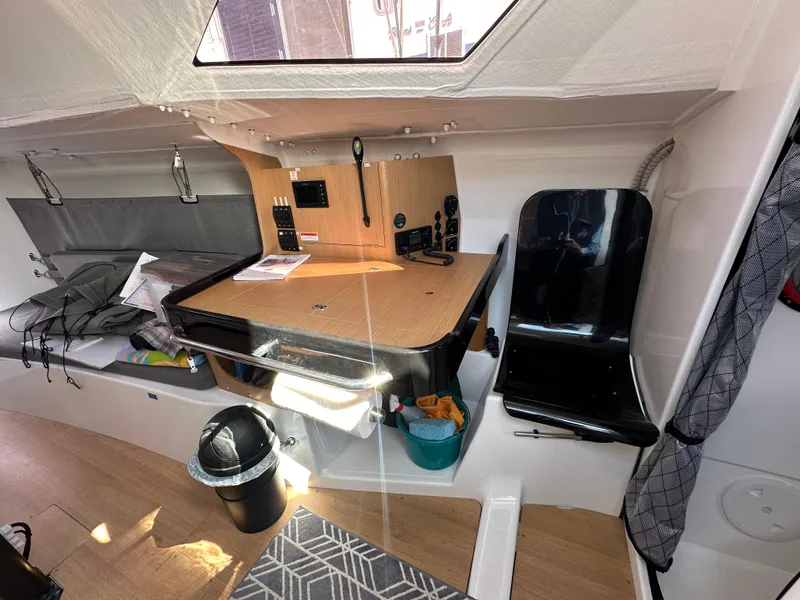 Slide: The Image of Interior of 2021 Jeanneau Sun Fast 3300 sailboat with navigation station and seating. - 35