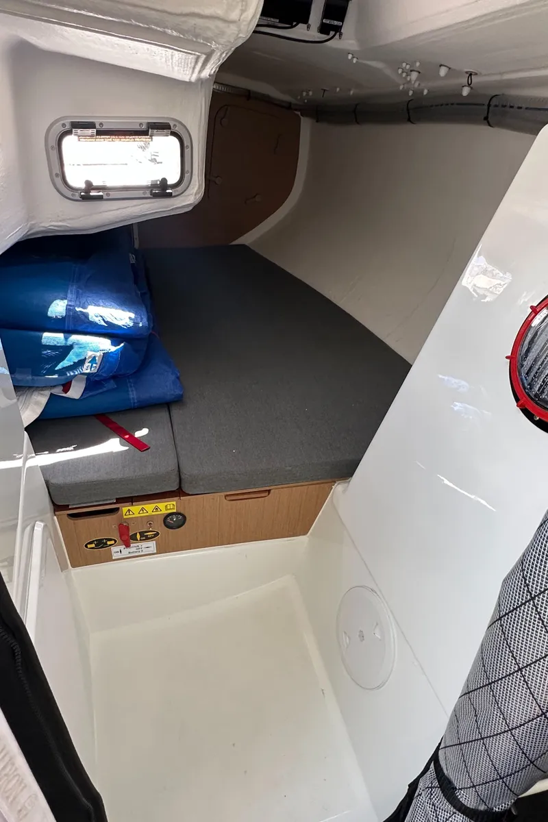 Slide: The Image of 2021 Jeanneau Sun Fast 3300 cabin interior with compact sleeping area and storage. - 36