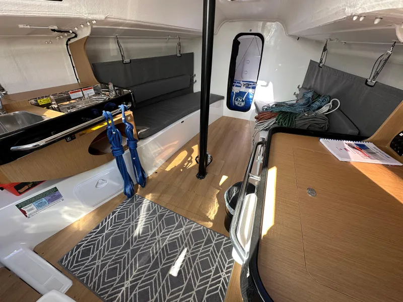 Slide: The Image of Interior of 2021 Jeanneau Sun Fast 3300 sailboat, featuring seating, table, and nautical equipment. - 39