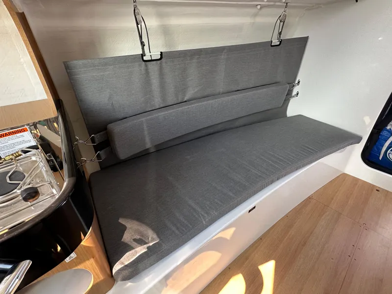 Slide: The Image of Interior of 2021 Jeanneau Sun Fast 3300 sailboat with gray cushioned seating. - 40