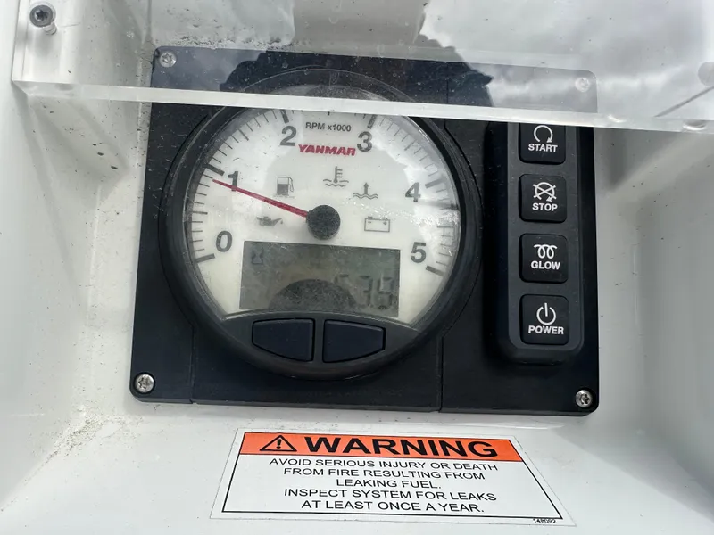Slide: The Image of Control panel of a 2021 Jeanneau Sun Fast 3300 with Yanmar RPM gauge and warning label. - 43