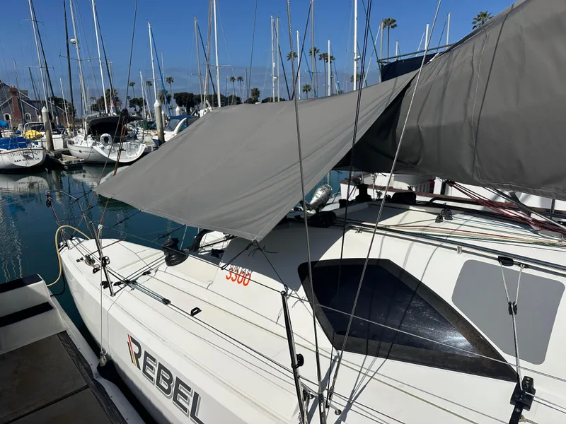 Slide: The Image of 2021 Jeanneau Sun Fast 3300 sailboat docked at marina, covered with a tarp. - 45