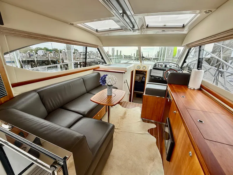 Slide: The Image of Luxurious interior of 2007 Riviera 3600 Sport Yacht with leather seating and wood finishes. - 11