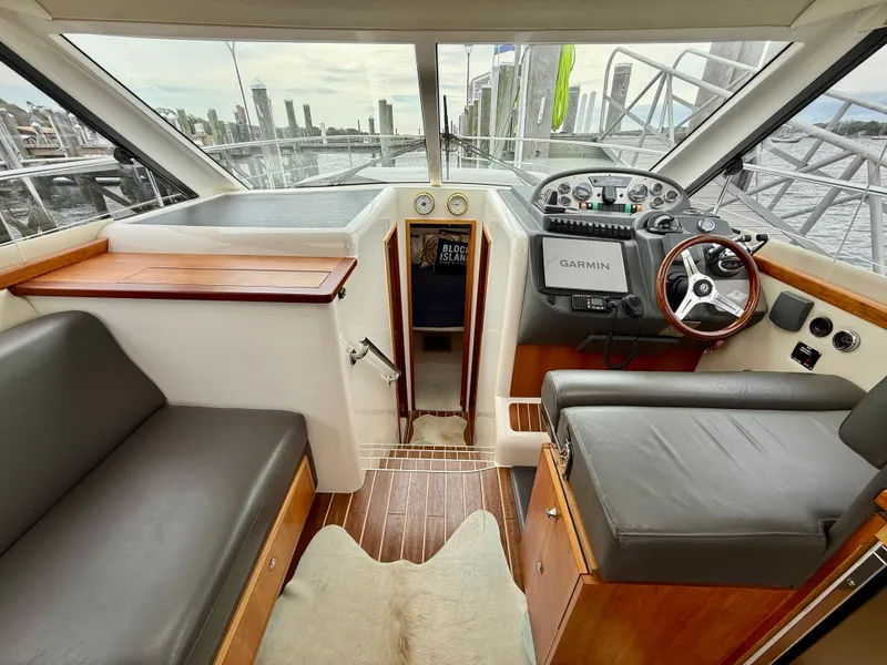 Slide: The Image of 2007 Riviera 3600 Sport Yacht interior with helm, seating, and navigation equipment. - 17