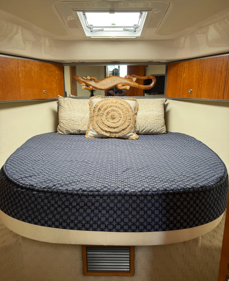 Slide: The Image of 2007 Riviera 3600 Sport Yacht cabin with cozy bed and decorative pillows. - 18