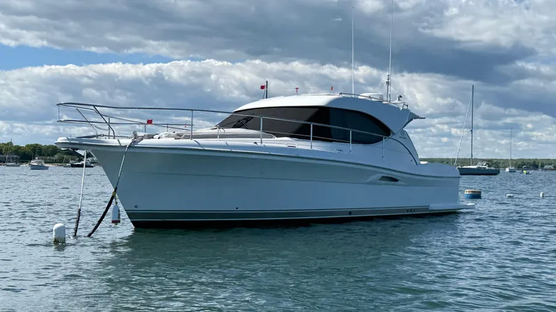 Slide: The Image of 2007 Riviera 3600 Sport Yacht on calm water under cloudy sky. - 2