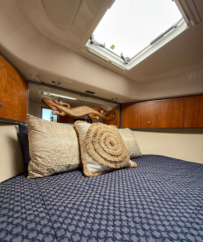 Slide: The Image of Interior of 2007 Riviera 3600 Sport Yacht cabin with skylight and decorative pillows. - 20
