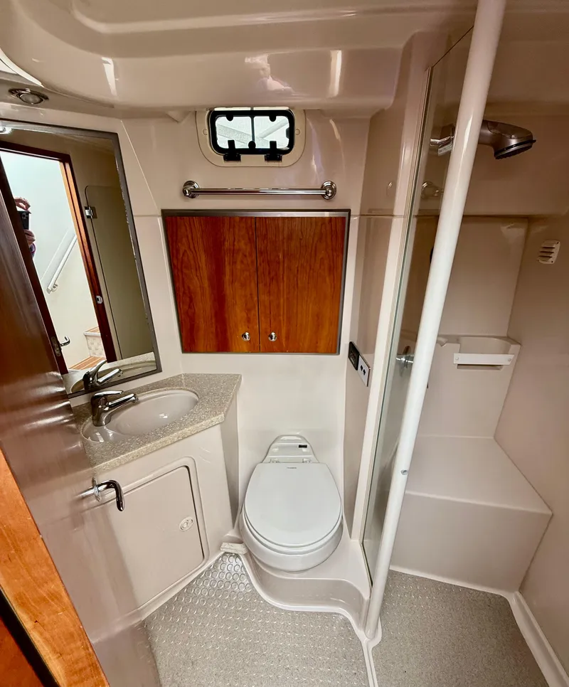 Slide: The Image of 2007 Riviera 3600 Sport Yacht bathroom with sink, toilet, and shower. - 27
