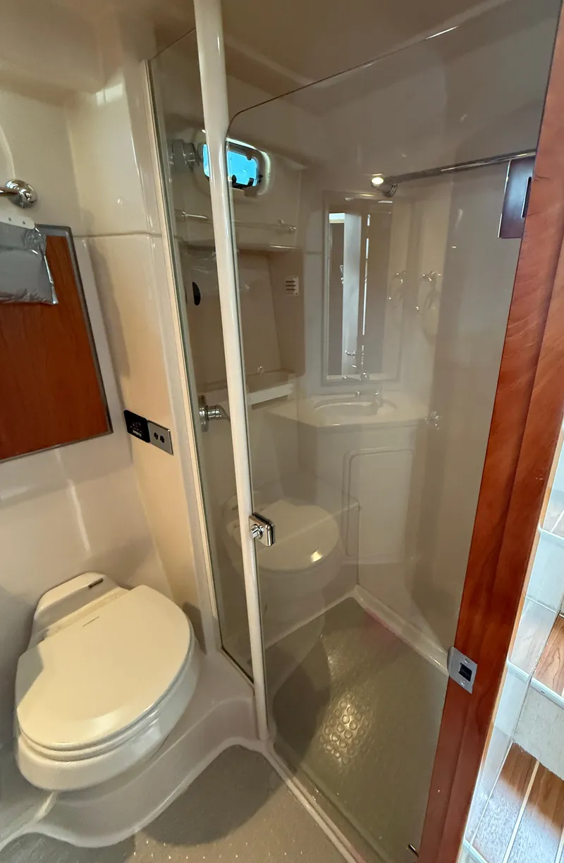 Slide: The Image of 2007 Riviera 3600 Sport Yacht bathroom with shower, toilet, and sink. - 28