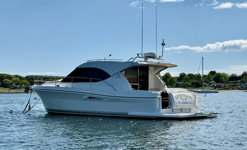 Slide: The Image of 2007 Riviera 3600 Sport Yacht on calm water, clear sky background. - 4