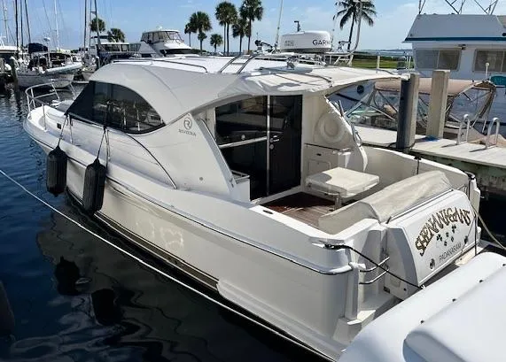 Slide: The Image of 2007 Riviera 3600 Sport Yacht docked at marina with palm trees in background. - 6