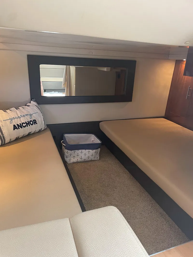 Slide: The Image of 2012 Regal 35 Sport Coupe interior with twin beds and nautical decor. - 12