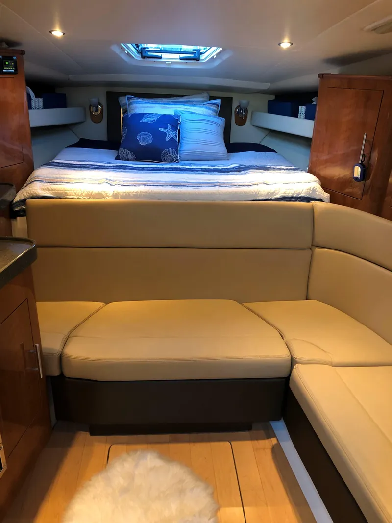 Slide: The Image of 2012 Regal 35 Sport Coupe interior with cozy bed and seating area. - 13