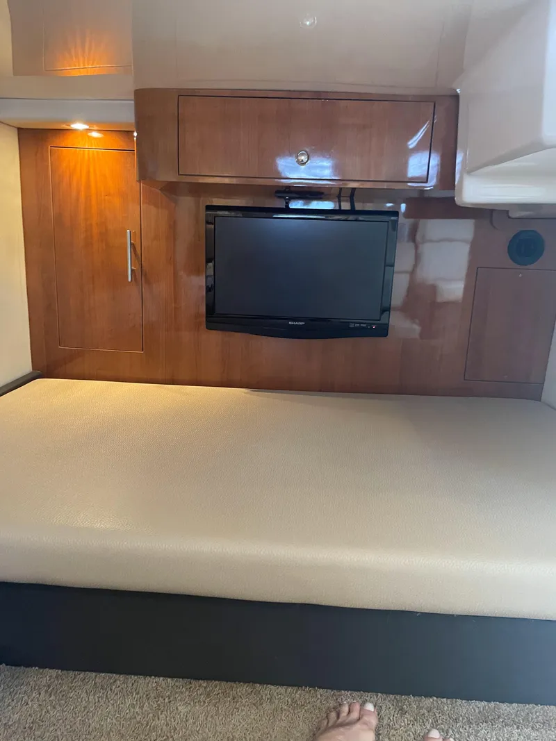 Slide: The Image of Interior cabin of 2012 Regal 35 Sport Coupe with TV and wooden cabinetry. - 14