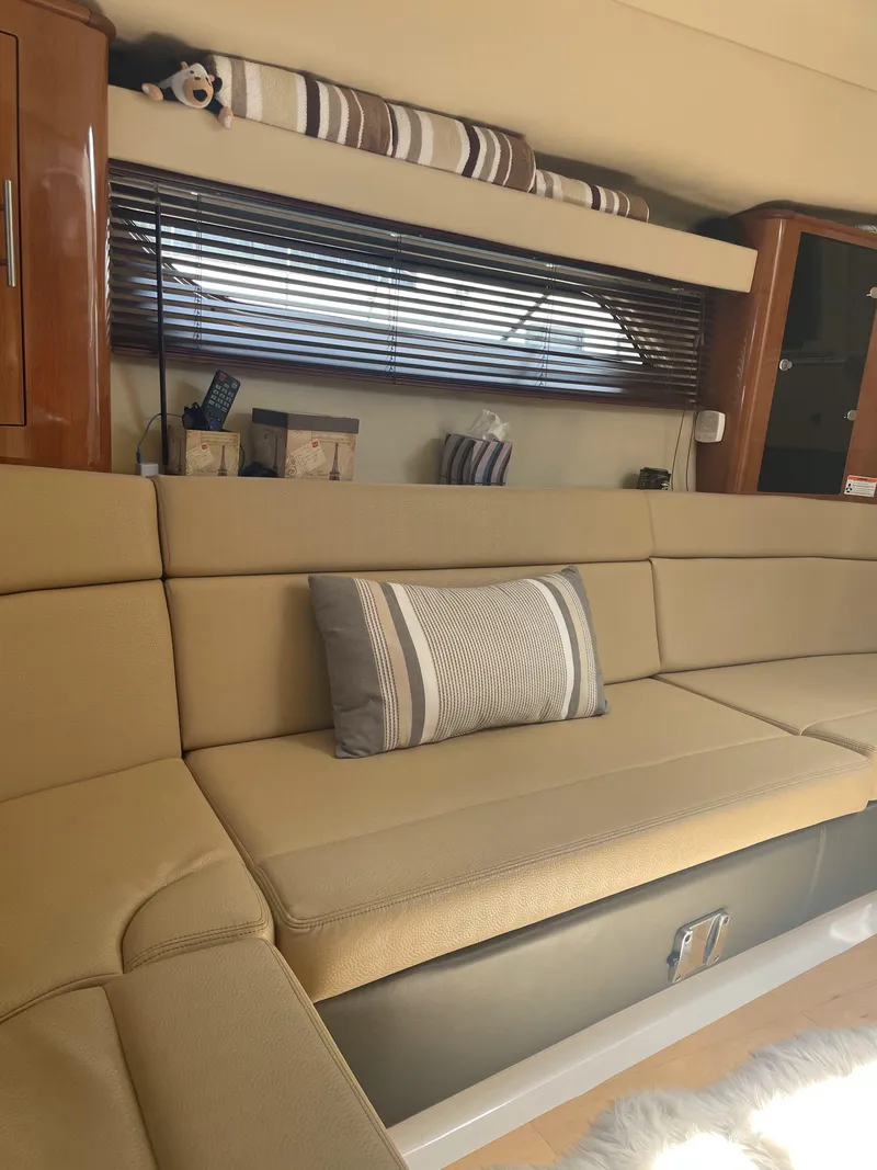 Slide: The Image of Luxurious interior of 2012 Regal 35 Sport Coupe with beige seating and striped decor. - 15