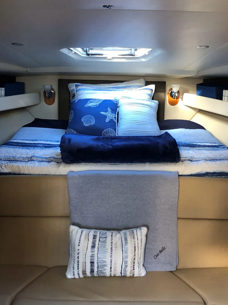 Slide: The Image of Luxurious interior of 2012 Regal 35 Sport Coupe with cozy bedding and ambient lighting. - 16