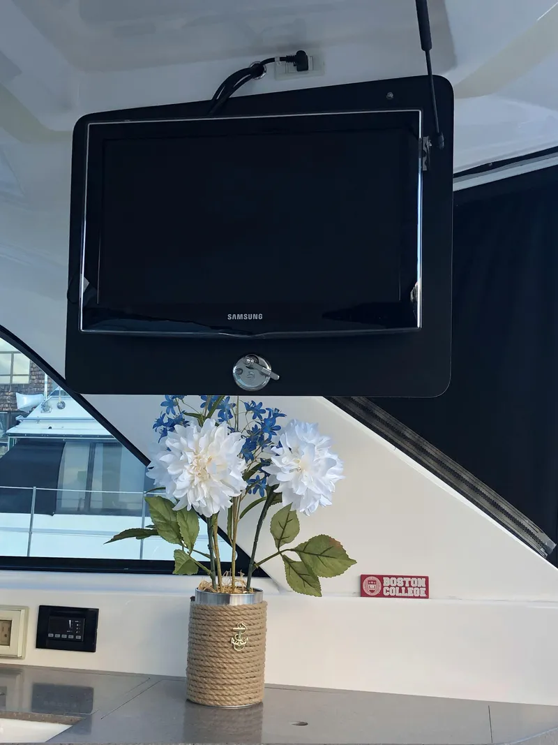 Slide: The Image of Samsung TV and flowers inside a 2012 Regal 35 Sport Coupe boat. - 17