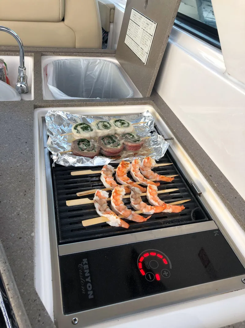 Slide: The Image of Grill on 2012 Regal 35 Sport Coupe with shrimp skewers and wrapped appetizers. - 18