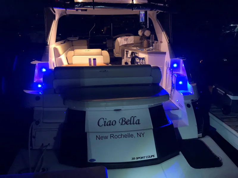 Slide: The Image of 2012 Regal 35 Sport Coupe yacht with blue lights, named "Ciao Bella," docked in New Rochelle, NY. - 3