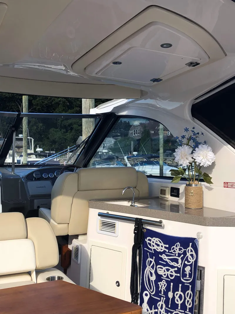 Slide: The Image of Interior of a 2012 Regal 35 Sport Coupe yacht with elegant seating and decor. - 4