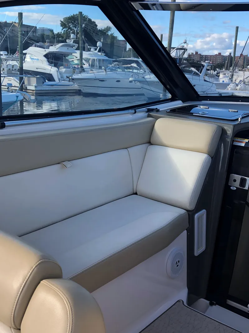 Slide: The Image of 2012 Regal 35 Sport Coupe interior with marina view, featuring beige and white seating. - 9