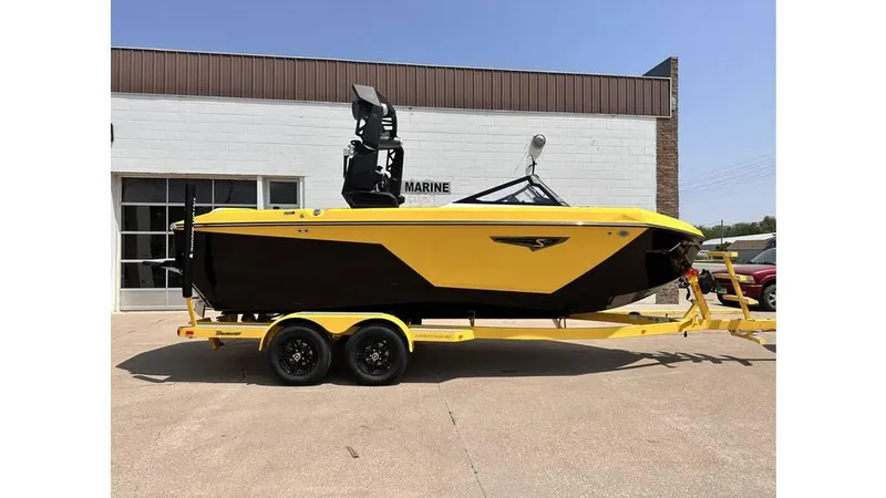 Slide: The Image of 2023 Nautique Super Air Nautique S21 boat in yellow and black on a trailer. - 1