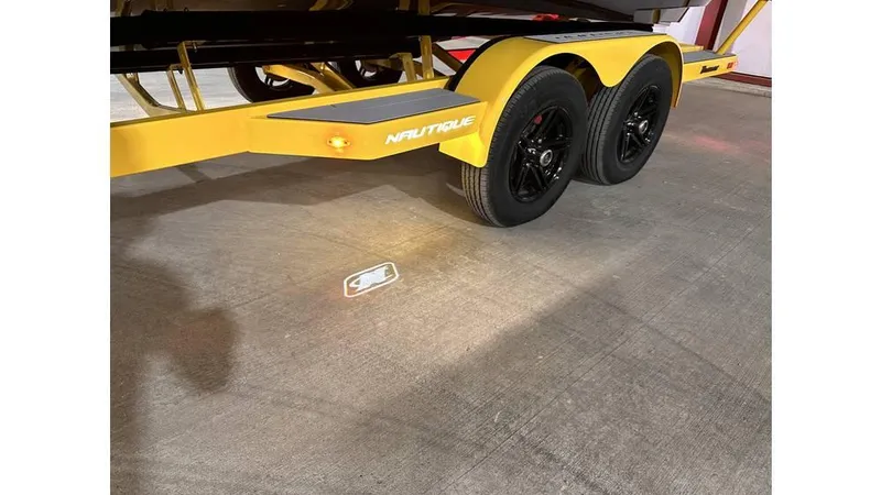 Slide: The Image of 2023 Nautique Super Air Nautique S21 trailer with yellow frame and black wheels. - 11