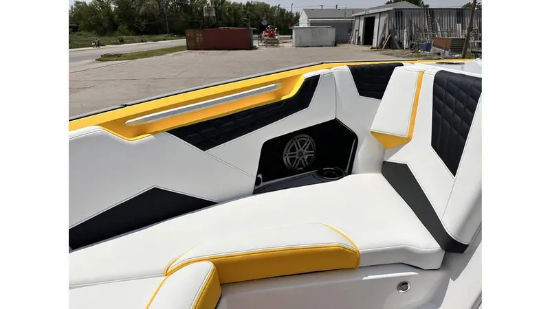 Slide: The Image of 2023 Nautique Super Air Nautique S21 interior with yellow and black accents. - 14