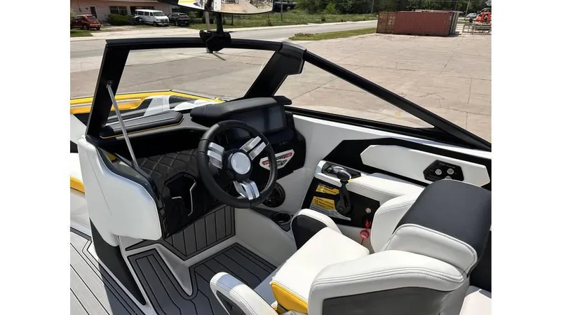 Slide: The Image of 2023 Nautique Super Air Nautique S21 cockpit with modern steering and seating. - 17