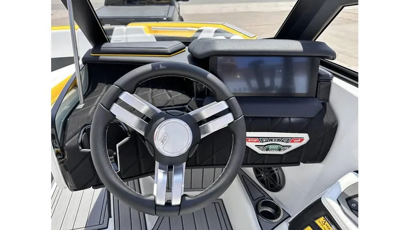 Slide: The Image of 2023 Nautique Super Air Nautique S21 dashboard with steering wheel and digital display. - 18
