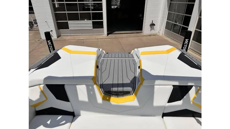 Slide: The Image of 2023 Nautique Super Air Nautique S21 boat with sleek design and vibrant yellow accents. - 20