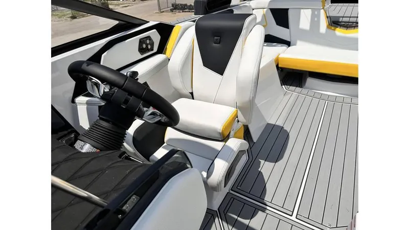 Slide: The Image of 2023 Nautique Super Air Nautique S21 interior with sleek white and yellow seating. - 21