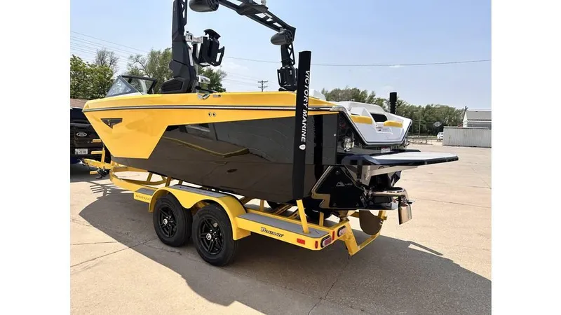 Slide: The Image of 2023 Nautique Super Air Nautique S21 boat in yellow and black on a trailer. - 5