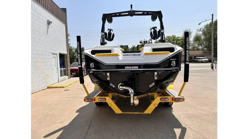 Slide: The Image of 2023 Nautique Super Air Nautique S21 boat on trailer, rear view in outdoor setting. - 6