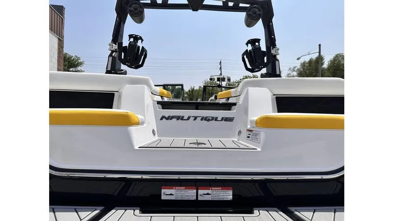 Slide: The Image of 2023 Nautique Super Air Nautique S21 boat with yellow accents, rear view. - 7